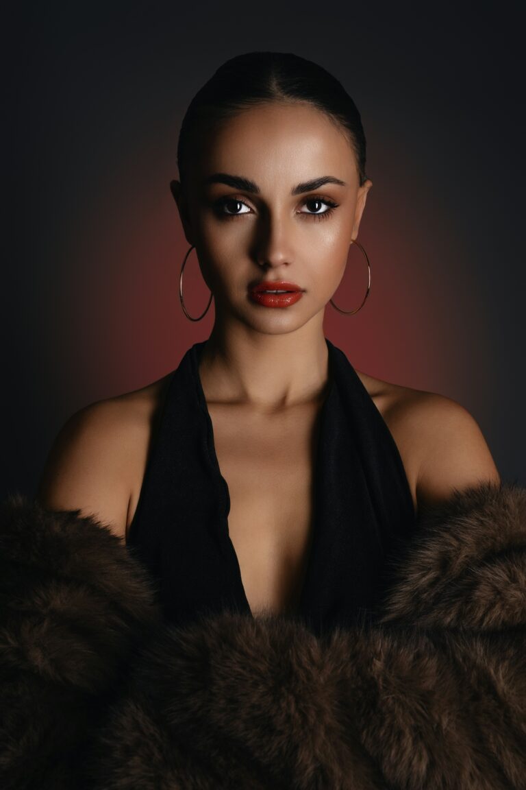 A woman in a black dress and fur coat